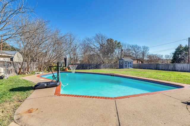 view of pool featuring a yard, a storage unit, and a patio