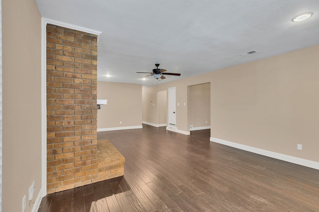 empty room with ceiling fan and dark hardwood / wood-style flooring