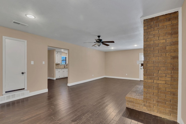 unfurnished living room featuring ceiling fan and dark hardwood / wood-style floors