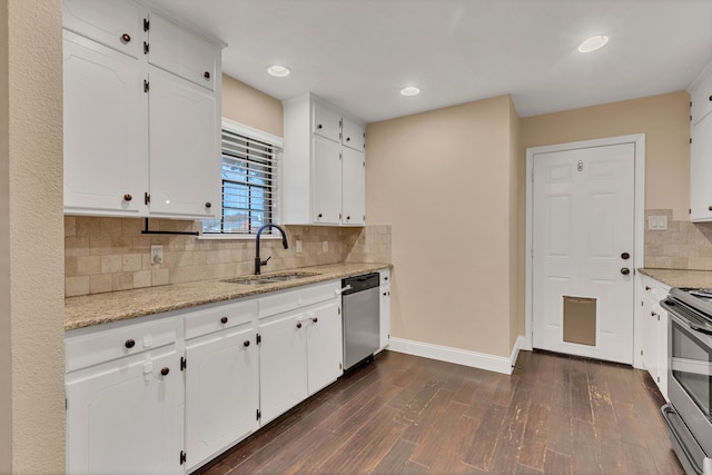 kitchen featuring appliances with stainless steel finishes, decorative backsplash, white cabinetry, and sink