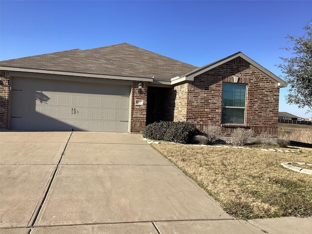 ranch-style home with a garage, roof with shingles, concrete driveway, and brick siding