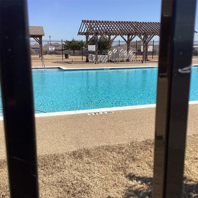 community pool featuring a patio area and fence