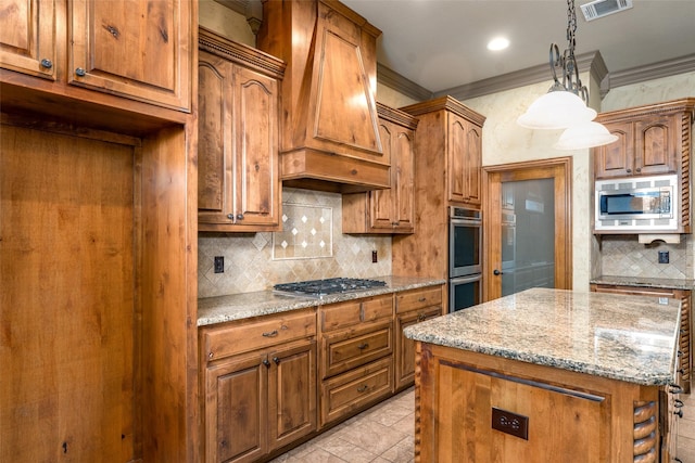 kitchen featuring light stone countertops, appliances with stainless steel finishes, a kitchen island, premium range hood, and hanging light fixtures