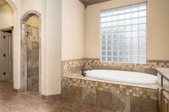 bathroom with vanity, separate shower and tub, and a healthy amount of sunlight