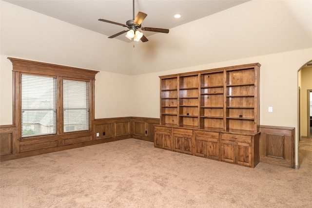 unfurnished living room with light carpet, vaulted ceiling, and ceiling fan