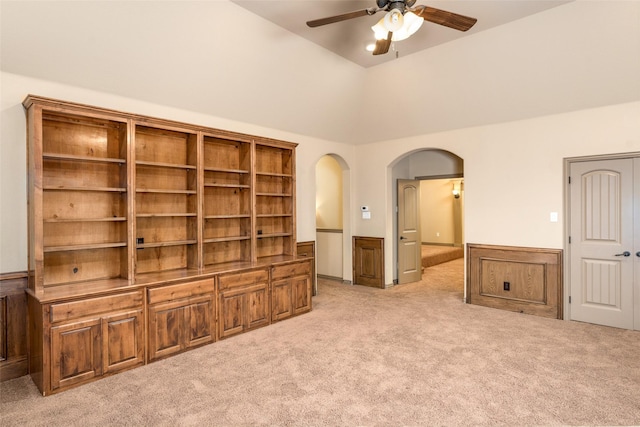 living room with lofted ceiling, light carpet, and ceiling fan