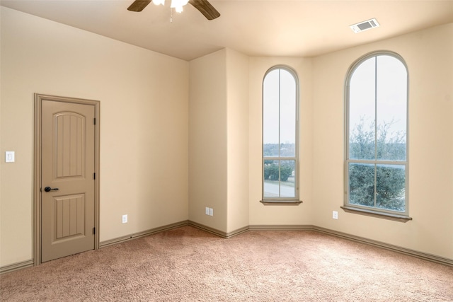 carpeted empty room featuring ceiling fan