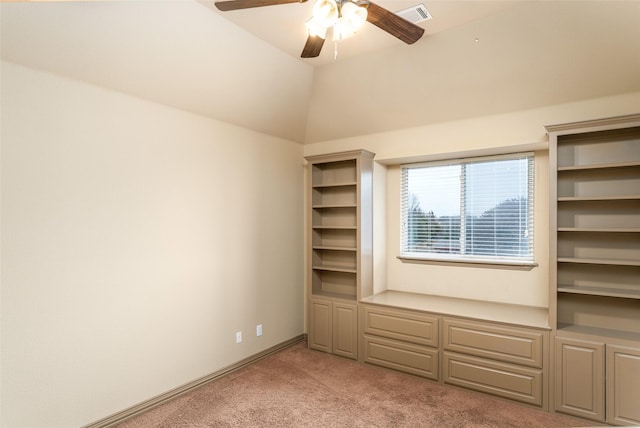 unfurnished bedroom with ceiling fan, light carpet, and vaulted ceiling