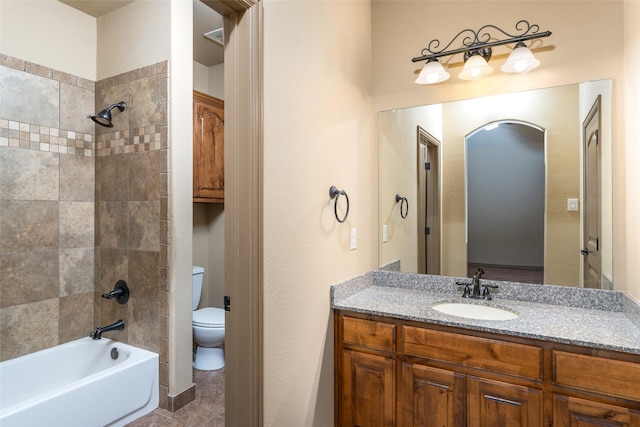 full bathroom featuring toilet, vanity, and tiled shower / bath combo