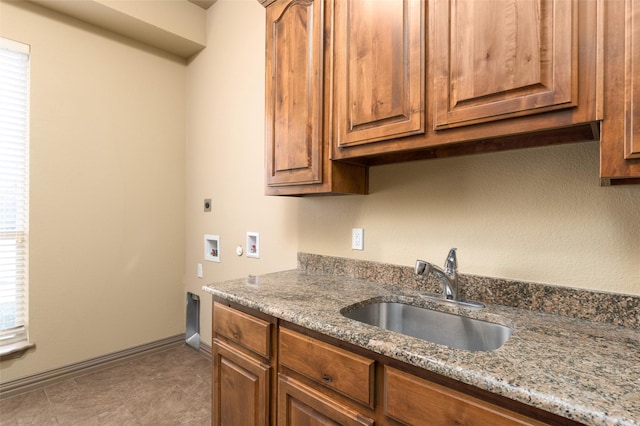 kitchen with sink and stone countertops