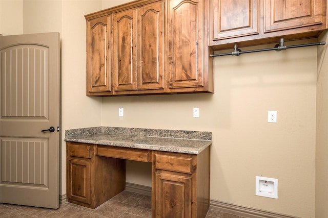 laundry room with washer hookup and cabinets