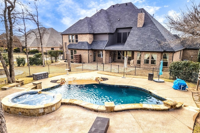 view of pool with an in ground hot tub and a patio