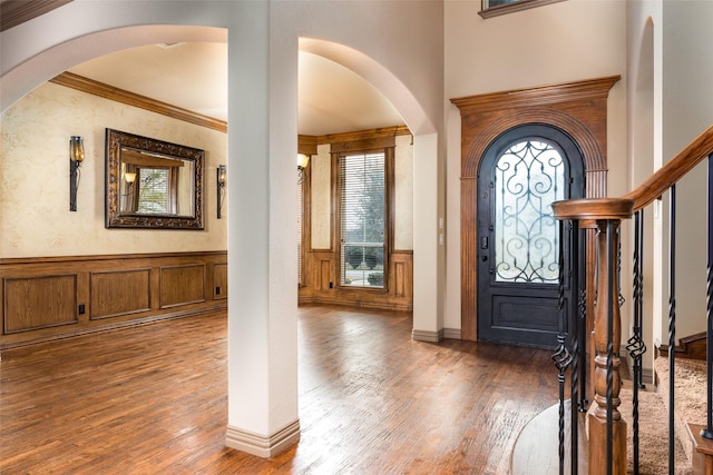 foyer entrance featuring dark hardwood / wood-style flooring and ornamental molding