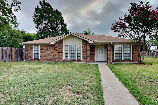 ranch-style home featuring a front yard