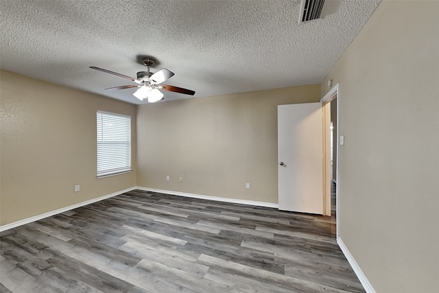 spare room with ceiling fan, dark wood-type flooring, and a textured ceiling