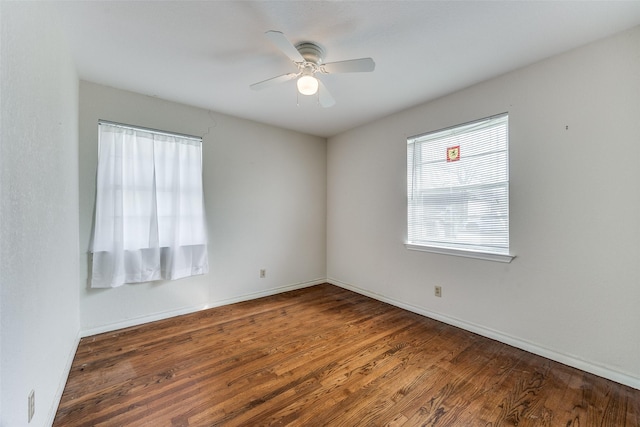 spare room with ceiling fan and dark wood-type flooring