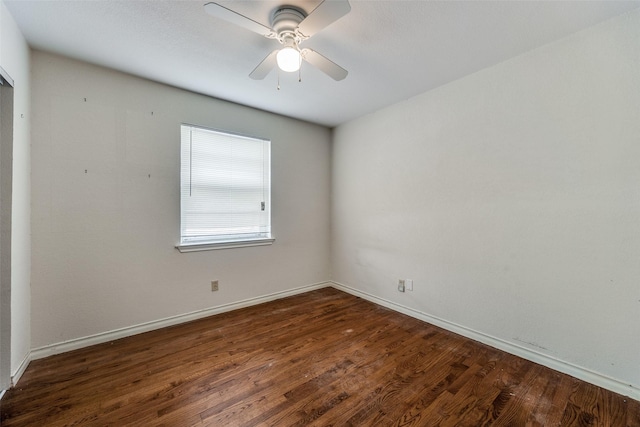 empty room with ceiling fan and dark hardwood / wood-style flooring