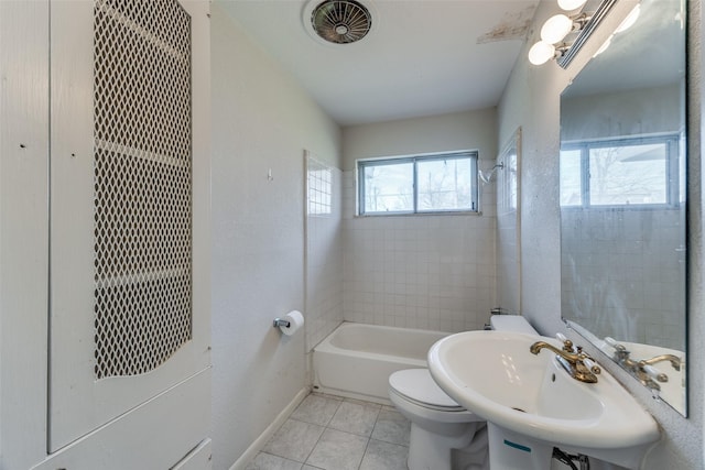 full bathroom with toilet, tiled shower / bath, tile patterned flooring, and sink