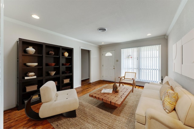 living room with hardwood / wood-style floors and crown molding