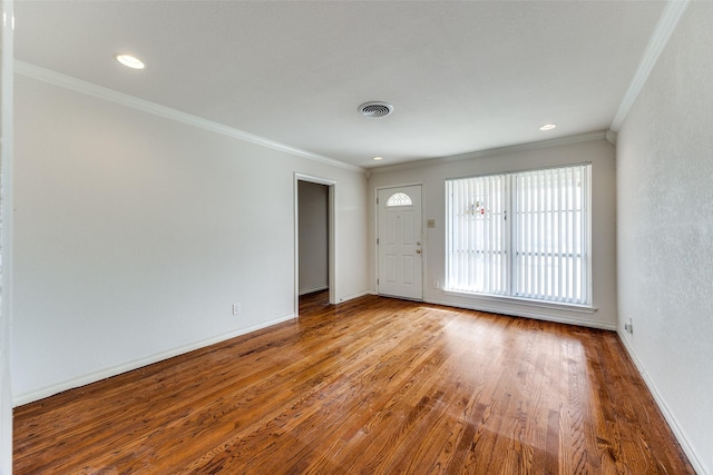 empty room with ornamental molding and light hardwood / wood-style flooring