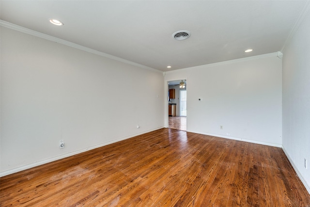 spare room featuring hardwood / wood-style flooring, ornamental molding, and ceiling fan