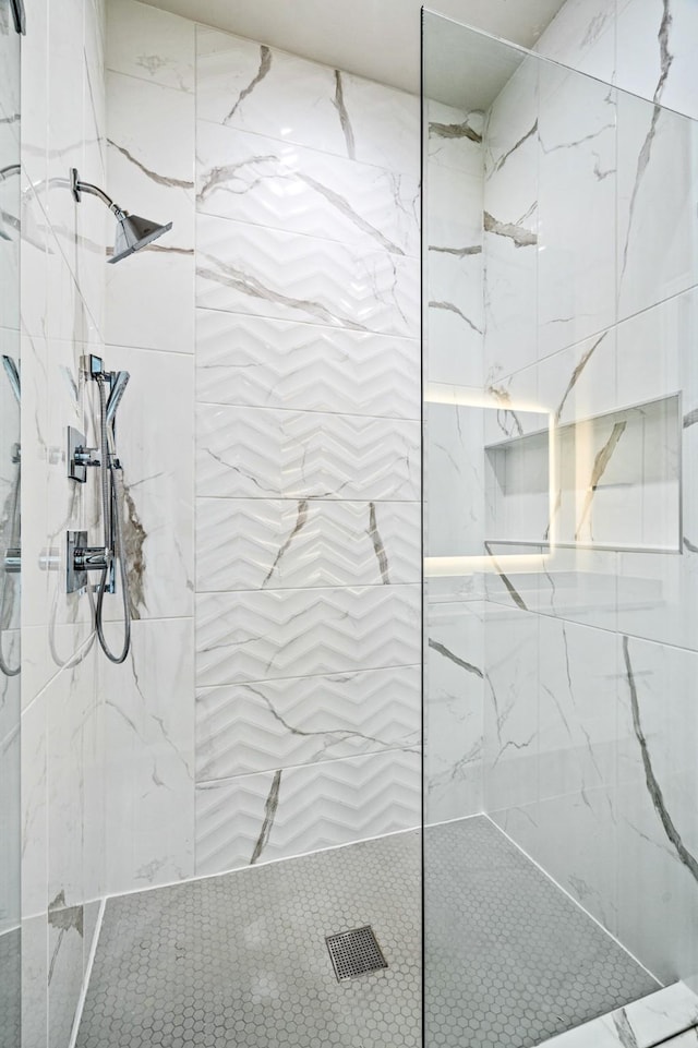 bathroom with a tile shower