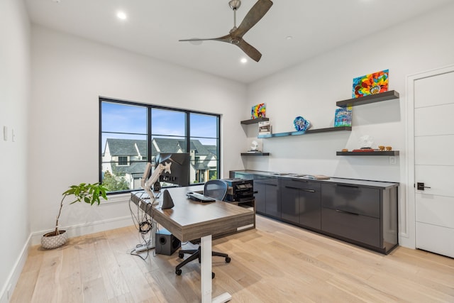 home office with ceiling fan and light hardwood / wood-style flooring