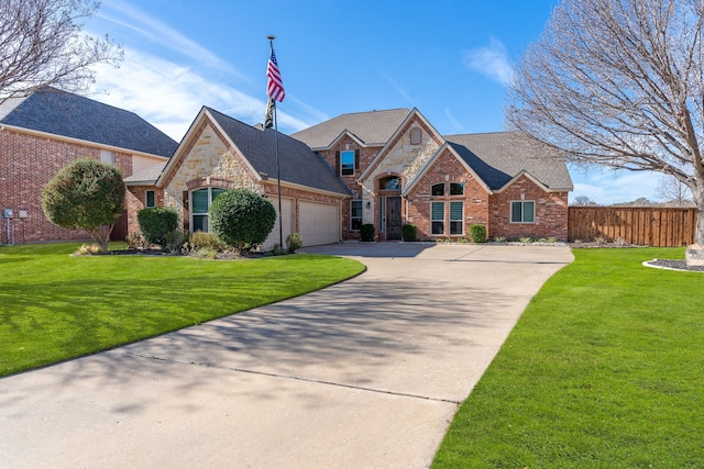 view of front of home with a garage and a front lawn