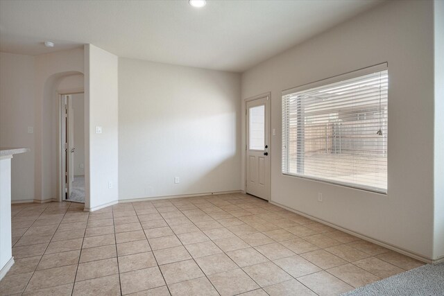 unfurnished room with light tile patterned floors