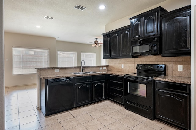 kitchen featuring kitchen peninsula, sink, light tile patterned floors, black appliances, and decorative backsplash