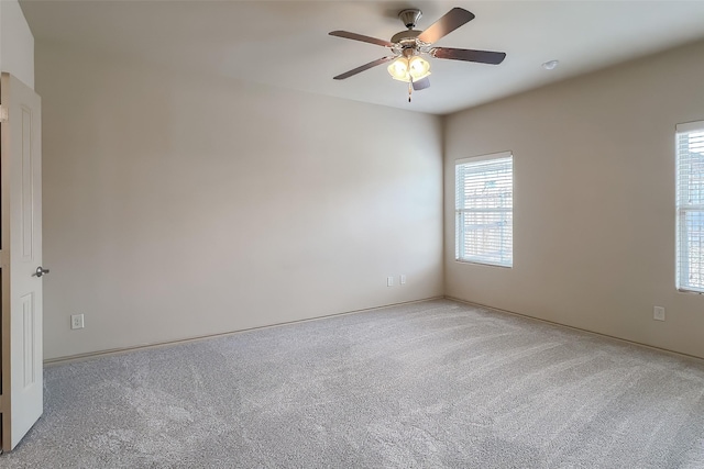 unfurnished room featuring ceiling fan and carpet floors