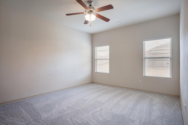 carpeted spare room with ceiling fan