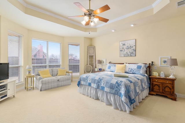 bedroom with ceiling fan, carpet, and a tray ceiling