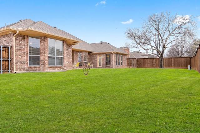 back of house featuring a yard