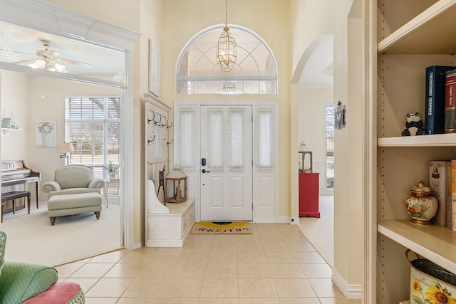 carpeted foyer featuring ceiling fan