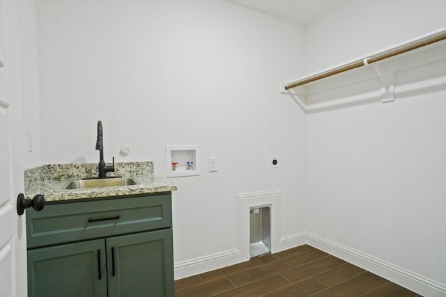 clothes washing area with cabinets, sink, hookup for a washing machine, and hookup for an electric dryer