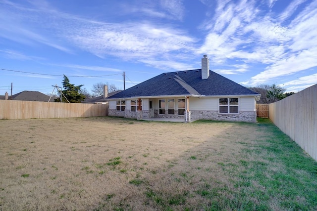 back of house featuring a patio area and a yard