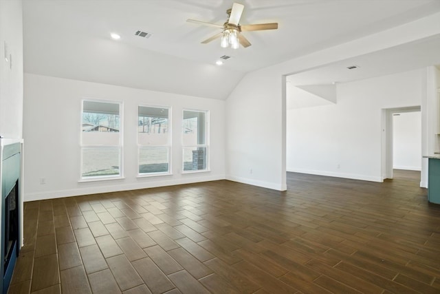 unfurnished living room with ceiling fan and vaulted ceiling