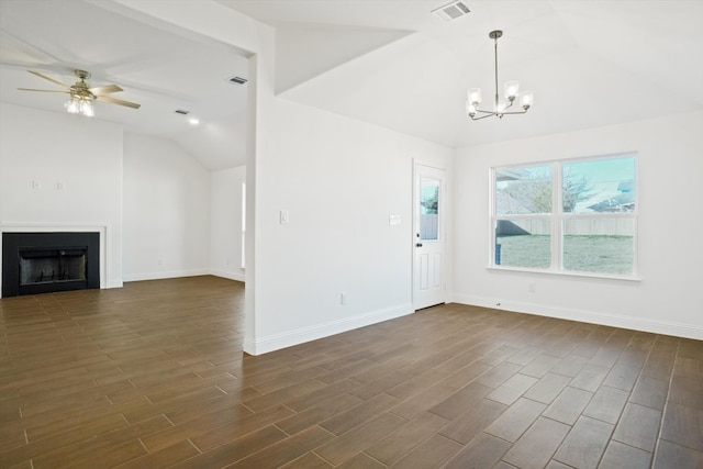 unfurnished living room with vaulted ceiling and ceiling fan with notable chandelier