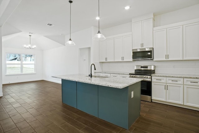 kitchen with appliances with stainless steel finishes, a kitchen island with sink, white cabinetry, and sink