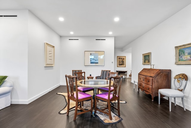 dining space with dark hardwood / wood-style flooring