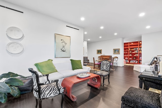 living room featuring a barn door and hardwood / wood-style flooring