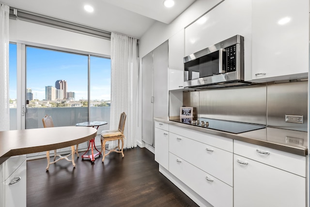 kitchen with white cabinetry, dark hardwood / wood-style flooring, and black electric cooktop