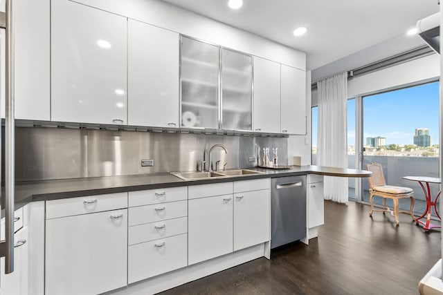 kitchen with white cabinets, dishwasher, dark hardwood / wood-style flooring, tasteful backsplash, and sink