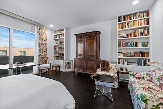 bedroom with dark hardwood / wood-style flooring