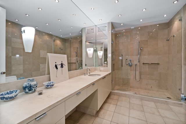 bathroom with vanity, tile patterned floors, and a shower with door