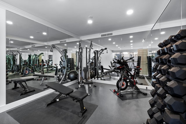 workout area featuring crown molding