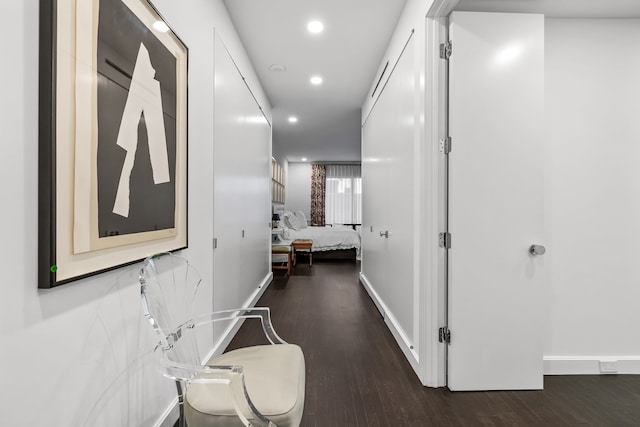 corridor with dark hardwood / wood-style floors