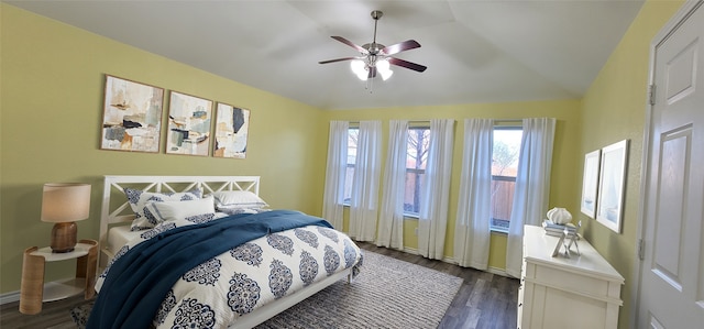 bedroom with dark wood-type flooring, ceiling fan, and vaulted ceiling