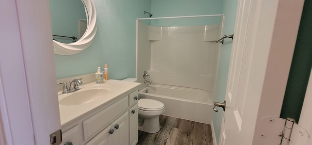 full bathroom featuring hardwood / wood-style flooring, shower / tub combination, vanity, and toilet